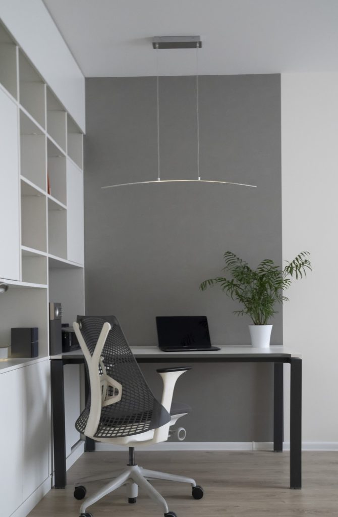 company-office-corner-with-a-modern-desk-orthopedic-chair-up-to-date-computer-and-green-flowerpot